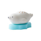 White seal figurine on a blue stand against a white background