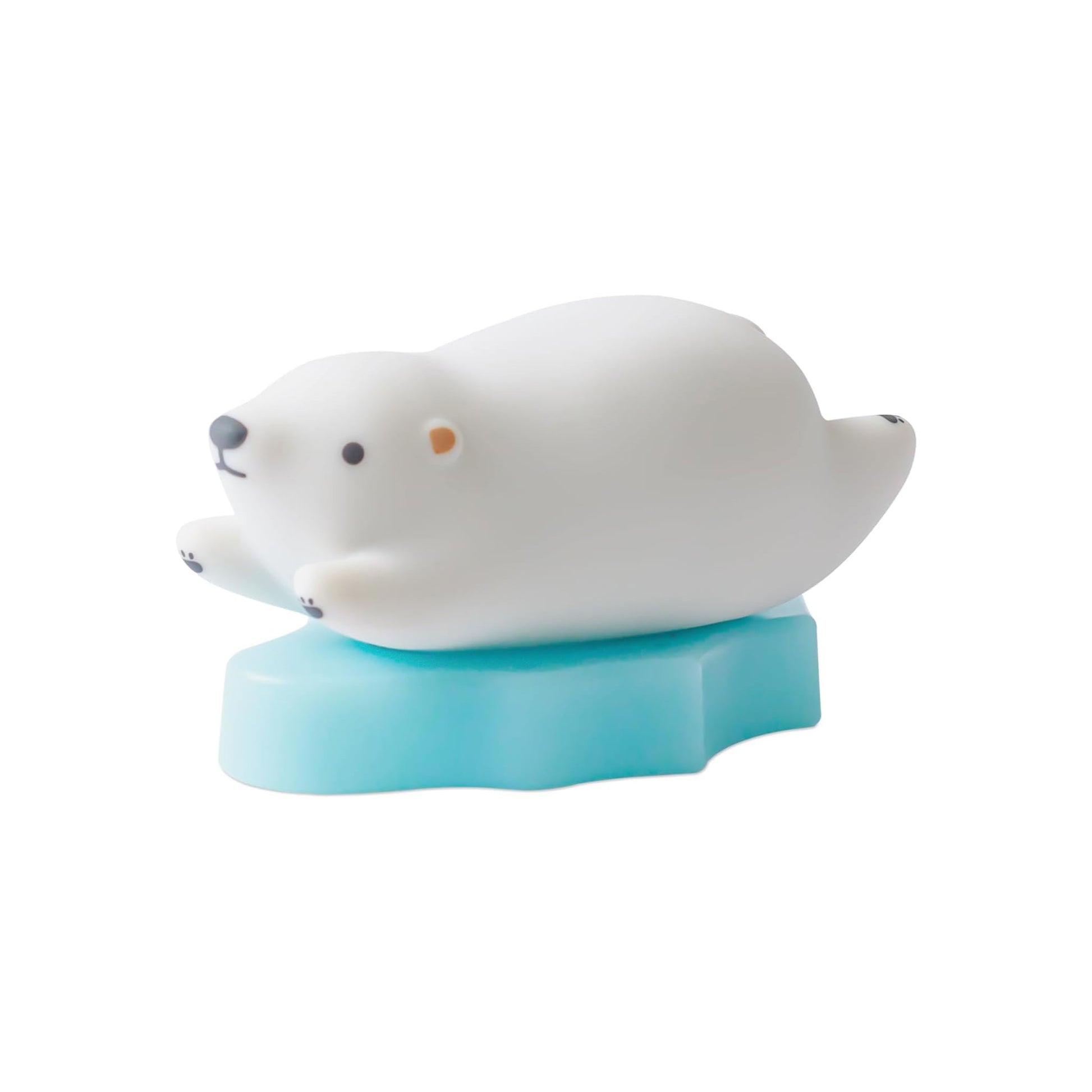 White seal toy on a blue stand against a white background