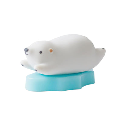 White seal toy on a blue stand against a white background