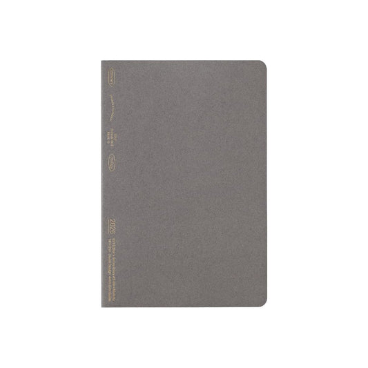 Gray notebook with gold accents on a white background
