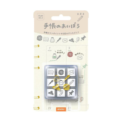 Packaged rubber stamps with various icons on a beige background