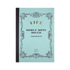 Notebook with decorative cover and 'Life Noble Note' text on a light blue background