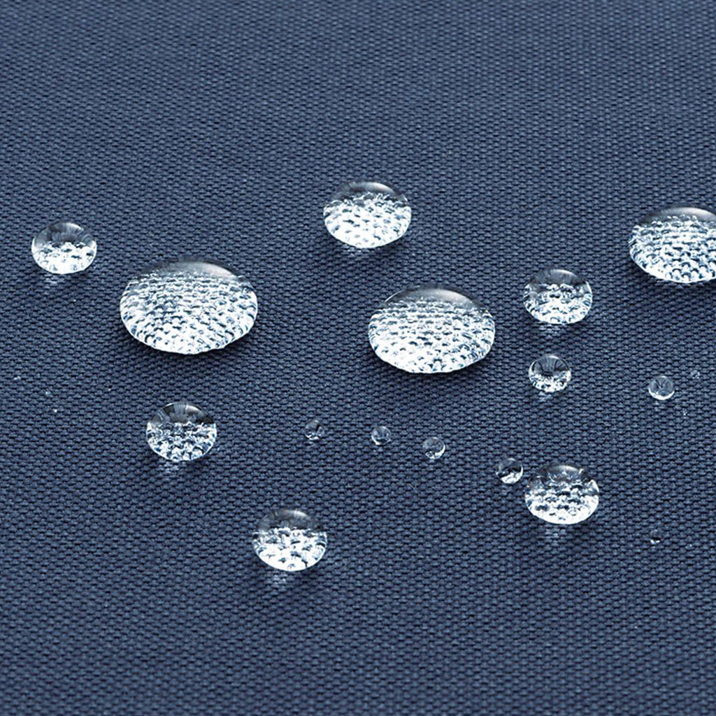 Clear, transparent oval gemstone cabochons with a textured, diamond-like surface arranged on a dark navy blue fabric background to demonstrate water repellency.
