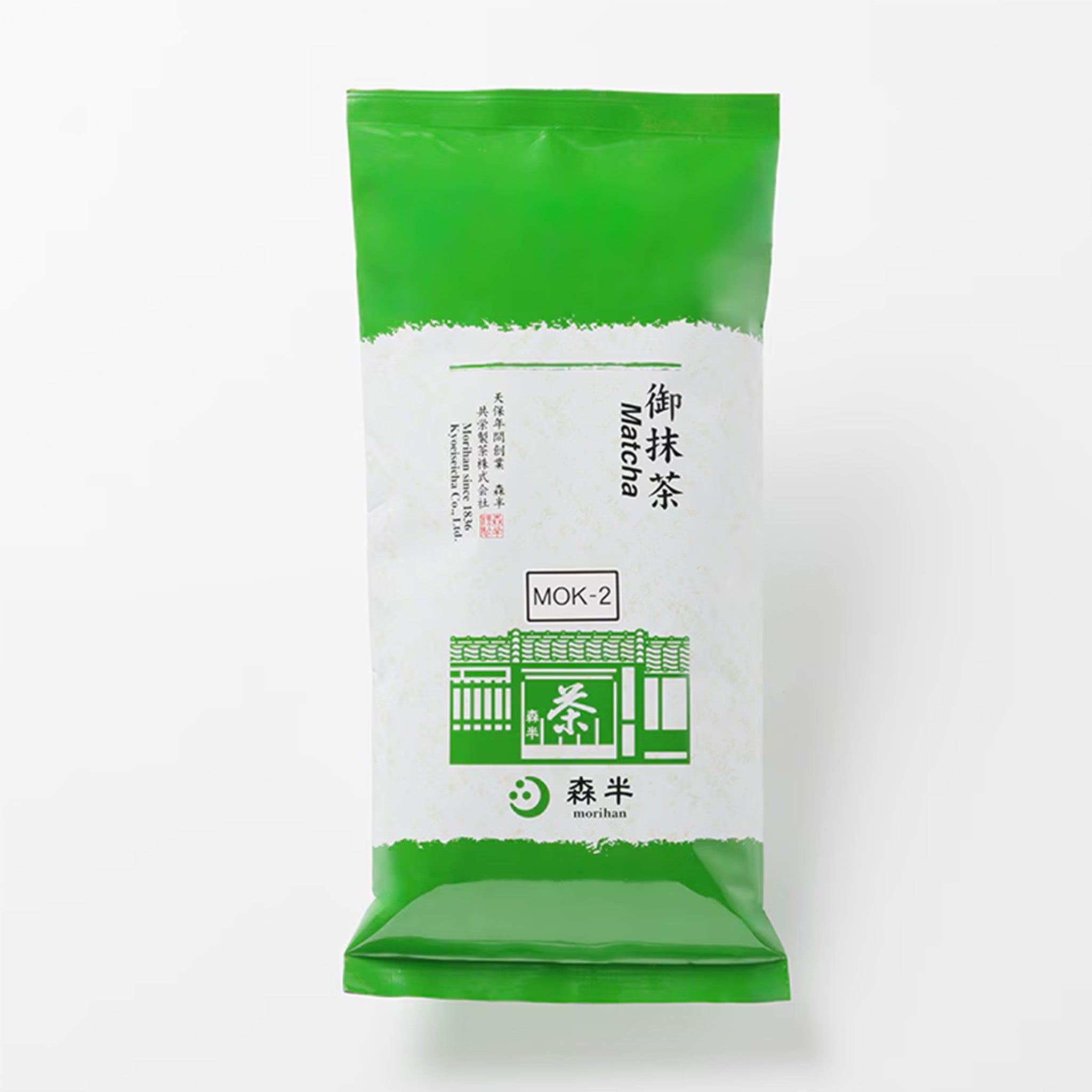 Green and white package of Mok-2 matcha powder on a white background