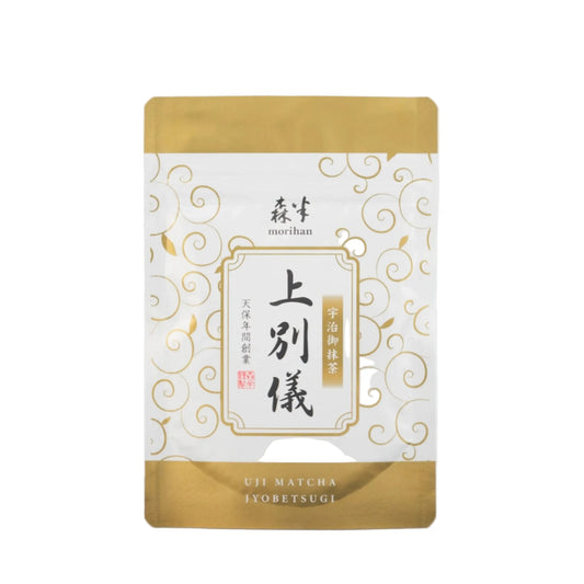 Tea package with gold and white design on a light gray background