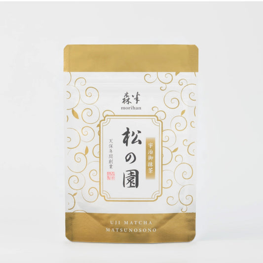 Matcha tea package with gold and white design on a white background