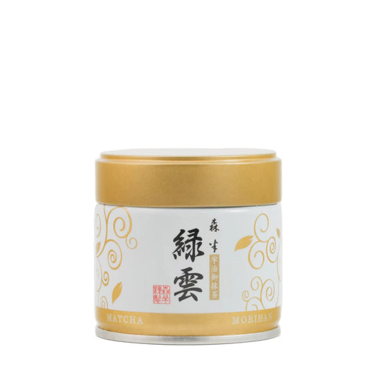 Matcha green tea canister with gold and white design on a white background